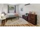Inviting bedroom featuring laminate floors, a neutral color palette, and a comfortable bed at 1438 Poinciana Dr, Clearwater, FL 33764