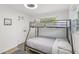 Bedroom featuring a bunk bed, two windows and closet space at 1438 Poinciana Dr, Clearwater, FL 33764