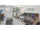Comfortable living room with a gray sectional sofa, a white door and natural light at 1438 Poinciana Dr, Clearwater, FL 33764