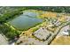 An aerial view shows a lake with walking paths, a bridge, and a parking area at 14509 Thornfield Ct, Tampa, FL 33624