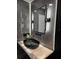 Stylishly designed bathroom featuring a black vessel sink, modern lighting, and marble accents at 14509 Thornfield Ct, Tampa, FL 33624