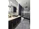 Modern bathroom with sleek vanity, vessel sink, and glass-enclosed shower at 14509 Thornfield Ct, Tampa, FL 33624