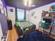 Vibrant bedroom with unique ceiling, gaming theme, and cozy decor at 14509 Thornfield Ct, Tampa, FL 33624
