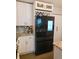 Kitchen with stainless steel appliances, granite countertops, white cabinetry, and an integrated wine rack at 14509 Thornfield Ct, Tampa, FL 33624