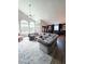 Spacious living room featuring a large sectional sofa, modern decor, and ample natural light from large windows at 14509 Thornfield Ct, Tampa, FL 33624