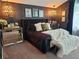 Cozy main bedroom with unique lighting fixtures, neutral carpet, and luxe decorative accents at 14509 Thornfield Ct, Tampa, FL 33624