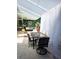 An outdoor dining area is featured, with a table setting with florals and a luxurious seating area with decorative curtains at 14509 Thornfield Ct, Tampa, FL 33624