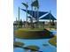 A playground climbing structure with blue shade coverings provides a fun recreation area at 14509 Thornfield Ct, Tampa, FL 33624
