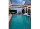 Covered pool and spa with ample seating and a privacy screen for outdoor gatherings at 14509 Thornfield Ct, Tampa, FL 33624