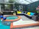 Outdoor seating area with stylish decor, plush cushions, and a view of the pool and hot tub at 14509 Thornfield Ct, Tampa, FL 33624