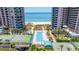 Stunning aerial view of the pool and amenities, set between two high-rise buildings near the beach at 1520 Gulf Blvd # 1502, Clearwater Beach, FL 33767
