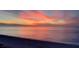 A breathtaking beach view showcasing tranquil water under a vibrant sunset sky at 1520 Gulf Blvd # 1502, Clearwater Beach, FL 33767