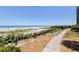 Scenic beach view with a walking path and clear blue sky at 1520 Gulf Blvd # 1502, Clearwater Beach, FL 33767