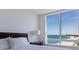 Bright bedroom featuring ocean view from large window with natural light at 1520 Gulf Blvd # 1502, Clearwater Beach, FL 33767