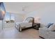 Cozy bedroom with tile floors, a ceiling fan, and a large window offering plenty of natural light at 1520 Gulf Blvd # 1502, Clearwater Beach, FL 33767