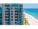 Luxury high-rise condo building with private balconies overlooking the white sand beach and clear ocean water at 1520 Gulf Blvd # 1502, Clearwater Beach, FL 33767