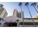 Entrance to underground parking and large condo building with palm trees at 1520 Gulf Blvd # 1502, Clearwater Beach, FL 33767