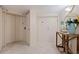 Hallway entrance with beige tile and wooden table with ocean-themed decoration and mirror at 1520 Gulf Blvd # 1502, Clearwater Beach, FL 33767