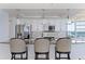 Modern kitchen with stainless steel appliances, granite countertops, breakfast bar, and beach views at 1520 Gulf Blvd # 1502, Clearwater Beach, FL 33767