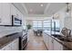Bright modern kitchen featuring white cabinets, granite counters, stainless appliances, and views of the ocean at 1520 Gulf Blvd # 1502, Clearwater Beach, FL 33767