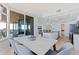 Modern kitchen featuring an island with seating, connecting to dining area with floor to ceiling ocean view windows at 1520 Gulf Blvd # 1502, Clearwater Beach, FL 33767