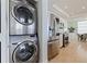 Convenient laundry area featuring a stacked washer/dryer adjacent to the modern kitchen with stainless appliances at 1520 Gulf Blvd # 1502, Clearwater Beach, FL 33767