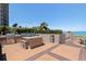 Outdoor kitchen with modern grills, prep area, and ocean views perfect for entertaining guests at 1520 Gulf Blvd # 1502, Clearwater Beach, FL 33767