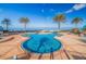 Sparkling pool area with tall palm trees and clear blue ocean views at 1520 Gulf Blvd # 1502, Clearwater Beach, FL 33767