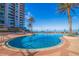 Beautiful outdoor swimming pool with tropical landscaping and ocean views at beachside highrise at 1520 Gulf Blvd # 1502, Clearwater Beach, FL 33767