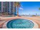 Luxurious pools and spas surrounded by brick pavers, tropical trees, and umbrella-shaded seating at 1520 Gulf Blvd # 1502, Clearwater Beach, FL 33767