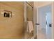 Walk-in shower featuring glass door, built-in shelves and tiled walls at 1520 Gulf Blvd # 1502, Clearwater Beach, FL 33767