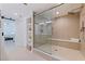 Open shower design featuring glass door, built in bench, and decorative beige wall tiles at 1520 Gulf Blvd # 1502, Clearwater Beach, FL 33767