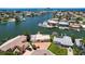 Scenic aerial view of a waterfront property with boat access and lush landscaping at 17444 2Nd E St, Redington Shores, FL 33708