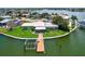 Aerial view showcasing waterfront property featuring a private dock and lush landscaping at 17444 2Nd E St, Redington Shores, FL 33708