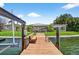 Waterfront property with a private wooden dock and a boat lift at 17444 2Nd E St, Redington Shores, FL 33708