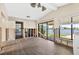Living room with tile floors and large windows overlooking the water view at 17444 2Nd E St, Redington Shores, FL 33708