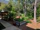 Landscaped backyard with lush greenery, mature trees, and wooden boardwalk at 1875 Harmony Dr, Clearwater, FL 33756