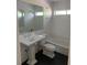 Elegant bathroom with a pedestal sink, subway tile walls, and a sleek, modern design at 1875 Harmony Dr, Clearwater, FL 33756