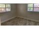 Well-lit bedroom featuring tiled floors, fresh paint, and classic plantation shutters at 1875 Harmony Dr, Clearwater, FL 33756