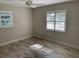 Comfortable bedroom with tile floors, bright natural light, and plantation shutters at 1875 Harmony Dr, Clearwater, FL 33756
