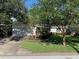 Charming single-story home with a well-manicured lawn and mature trees, offering great curb appeal at 1875 Harmony Dr, Clearwater, FL 33756