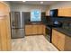 Modern kitchen featuring stainless steel appliances, granite countertops, and sleek cabinetry at 1875 Harmony Dr, Clearwater, FL 33756