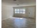 Bright and airy living room with tiled floors, plantation shutters, and a fresh, neutral color palette at 1875 Harmony Dr, Clearwater, FL 33756