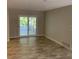 Inviting living area featuring tiled floors and sliding glass doors that open to the outdoor patio at 1875 Harmony Dr, Clearwater, FL 33756
