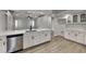 Bright kitchen with white cabinets, stainless steel appliances, quartz countertops, and a large island sink at 23344 Van Buren Ave, Punta Gorda, FL 33980