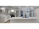 Bright kitchen with white cabinets, quartz countertops, stainless steel appliances, and a large island sink at 23344 Van Buren Ave, Punta Gorda, FL 33980