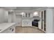 Modern kitchen with white cabinets, stainless steel appliances, quartz countertops, and updated fixtures at 23344 Van Buren Ave, Punta Gorda, FL 33980