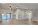 Open-concept living room with hardwood floors, a ceiling fan, and sliding glass doors with pool views at 23344 Van Buren Ave, Punta Gorda, FL 33980