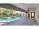 A screened-in pool and patio area feature ample sunlight and access to the home's interior via sliding glass doors at 23344 Van Buren Ave, Punta Gorda, FL 33980