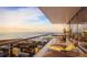 Enjoy breathtaking ocean views from this spacious balcony with elegant outdoor seating and glass railings at 235 1St S Ave # 2405, St Petersburg, FL 33701